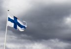Finnish flag in front of dark clouds