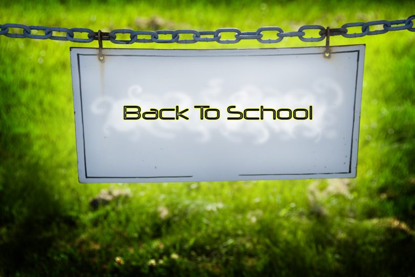 A sign hung on a chain that says Back To School.